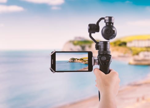 Smartphone shooting concept Isle of Wight tourist attraction in summer, England, UK.