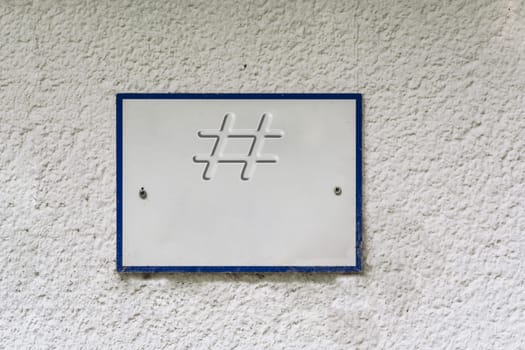 Sign or board on a house wall with inscription #.