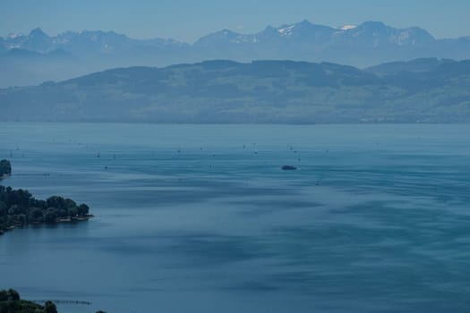 Lake Constance in summer with boats and views of the Alps of Switzerland