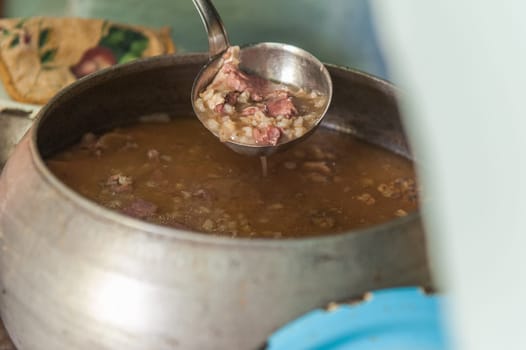 Cooking meals in a Russian stove, soup with meat and groats
