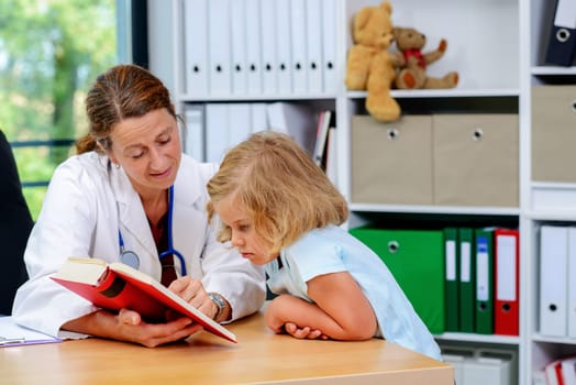 female pediatrician in white lab coat and the little patient