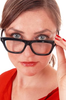 A beautiful young woman holding her black glasses, looking over the.glasses with nice blue eyes, isolated for white background..