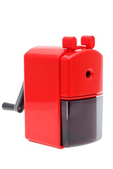 Red plastic pencil sharpener on white background