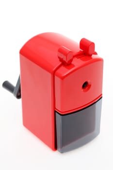 Red plastic pencil sharpener on white background