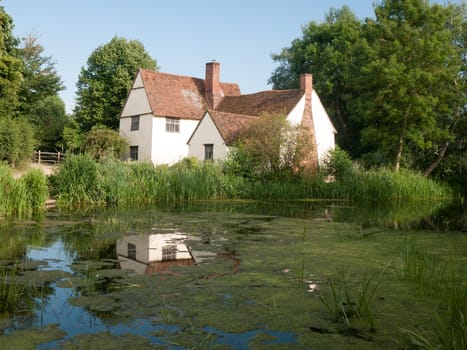 Willy Lotts' cottage and river front on a clear sunny day  Suffolk  UK