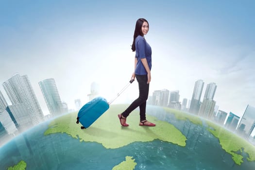 Traveler asian woman walking carrying suitcase with futuristic background