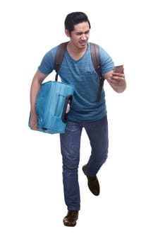 Portrait of hurry asian traveler running with carrying suitcase isolated over white background