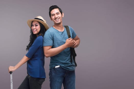 Traveler asian couple with happy expression over bright background