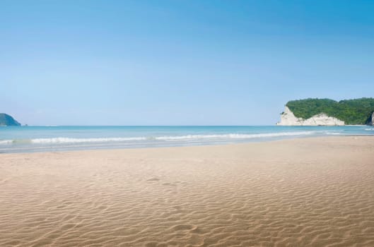 Landscape view of tropical beach with blue sea at sunny day