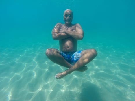 Underwater image of a happy man diving