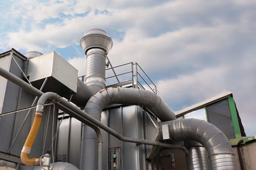 Industrial factory air filtration system. Tubes, tank and chimney.