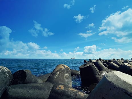 Huge stones in the sea at Balchik city, Bulgaria. Summer vacation background with a ship floating on far.