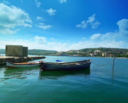 Floating boats in the sea near the pear at Balchik city, Bulgaria. Summer vacation background. Joy, happiness and recreation concept
