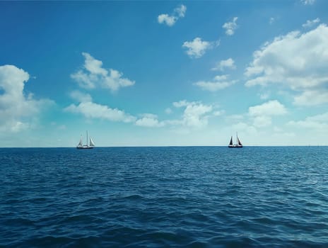 Two ships floating on the ocean in a sunny day
