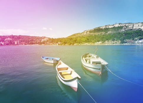 Floating boats near the pear in the Black Sea at Balchik city, Bulgaria. Summer vacation background. Joy, happiness and recreation concept