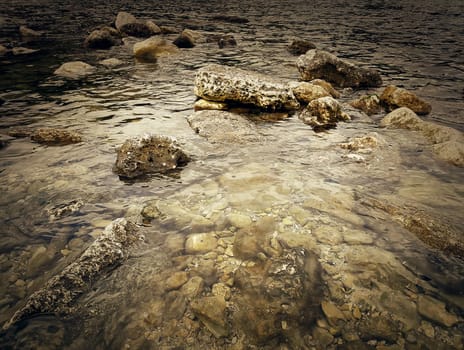 Underwater texture of a rocky seafloor with stone pieces
