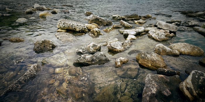Underwater texture of a rocky seafloor with stone pieces