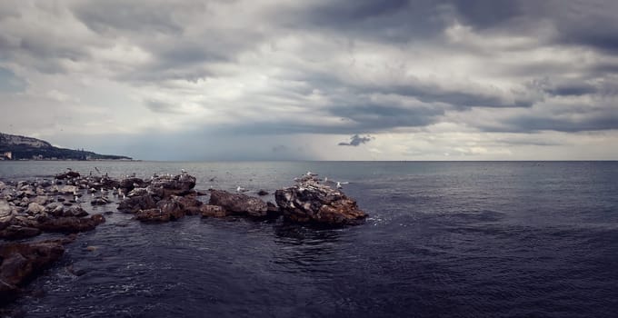 Seascape with a dramatic cloudy sky. Beautiful view at the coast of the Black Sea in Balchik city, Bulgaria.