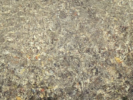 Underwater texture with the light on a rocky seafloor