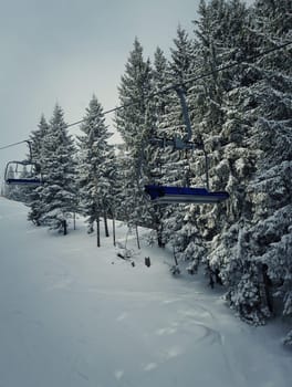 Chair lift at ski resort in sun winter day. Carpathian Mountains, Ukraine.