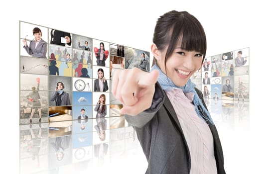 Confident Asian business woman point at you standing in front of TV screen wall, closeup portrait.