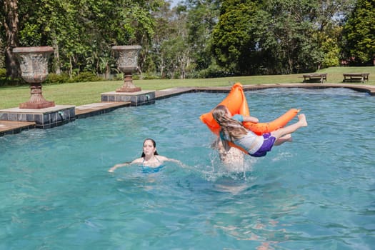 Girl Boy playing in swimming pool home summer