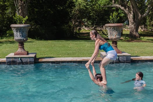 Girl, Boy playing in swimming pool home summer