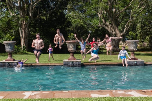 Girls boys teenagers young running jumping into home  swimming pool summer playtime