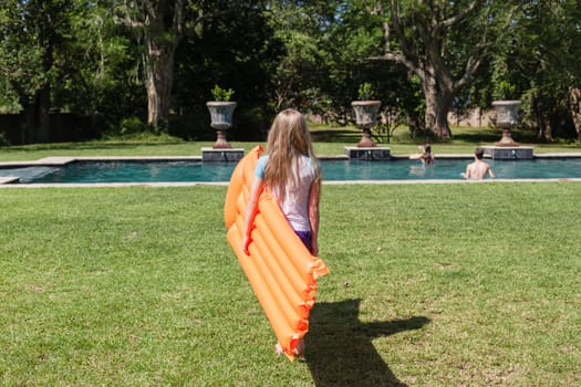 Girl Boy playing in swimming pool home summer