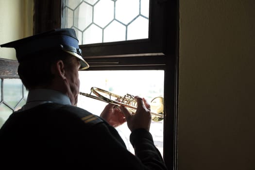 The tower blaeser at a trumpet signal on the tower of St. Mary's Church in the old town of Krakow in the south of Poland.