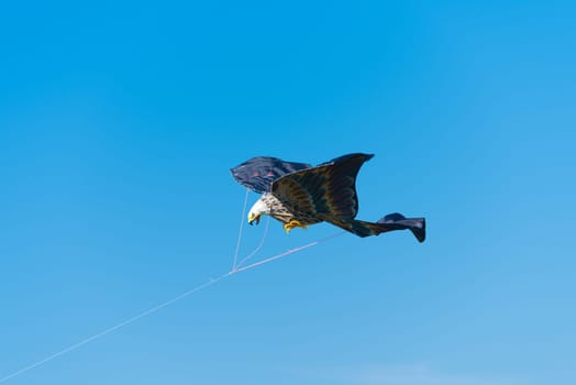 eagle shaped kite against a blue sky