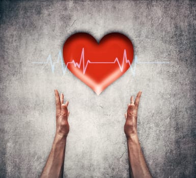 Closeup of two human hands holding a red heart with ecg line. Healthcare, medicine and charity concept
