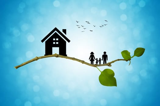 Tree branch with silhouettes of house and family. The concept of a happy family. Eco life
