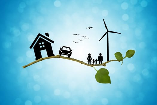 Environmental green energy concept. Silhouette of happy family, house, car and windmill on a tree branch