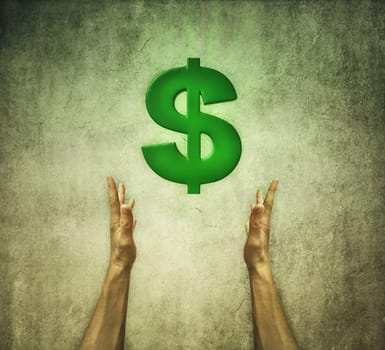 Closeup of two human hands holding a green dollar sign. Financial concept