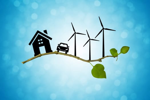 Environmental green energy concept. Silhouette of house, car and wind turbine on a tree branch