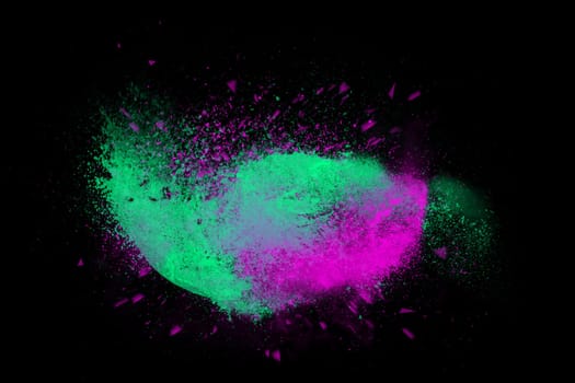 Freeze motion of colorful powder paint exploding isolated on black dark background. Abstract design of color dust cloud. Particles explosion screen saver, wallpaper, brush