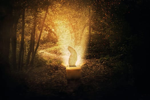 Magical cardboard box opened in a dark forest and a mystic creature with angel wings escape through a lot of fireflies and sparkles. The parcel from paradise, freedom concept.