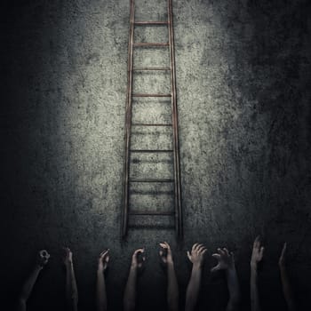 Abstract idea concept as a lot of human hands stretched out to reach a ladder and escape from a dark room prison. Surrounded by limitations, danger and fear symbol.