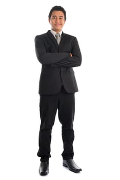 Full body attractive young Southeast Asian businessman arms crossed standing isolated on white background. Asian malay male model.