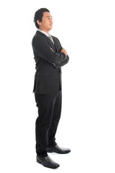 Full body arm crossed young Southeast Asian businessman standing isolated on white background.