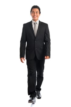 Full body attractive young Southeast Asian businessman walking, isolated on white background. Asian malay male model.