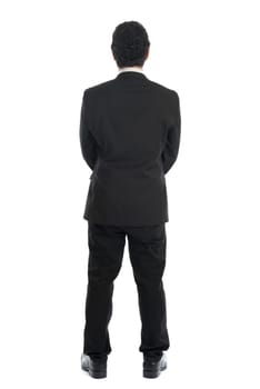 Full body back view of young Southeast Asian businessman standing isolated on white background.