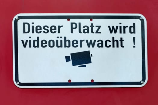 Video monitoring sign on a red background