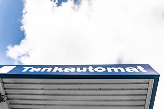 Lettering tank machine on the exterior façade of a roof