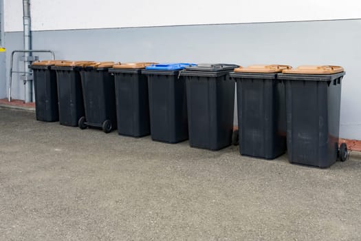 Grey garbage cans in a row