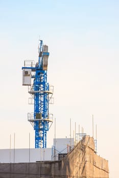 Construction site with cranes on sky background