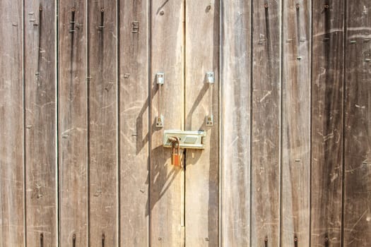 Padlock on wooden background, pad lock secures an old door