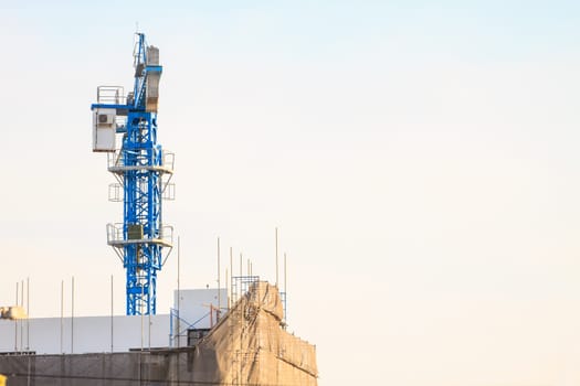 Construction site with cranes on sky background