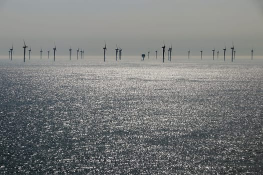 Offshore wind farm in the sea. Wind turbine in the water